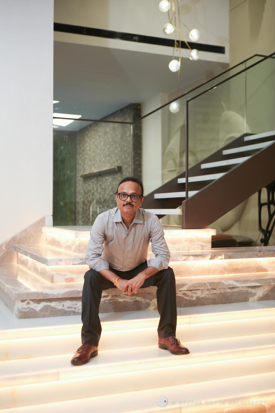 Deepak Gupta seated on the lit stone steps of the GK residence